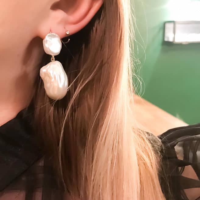 Baroque 14 kt gold freshwater pearl earrings, model view.